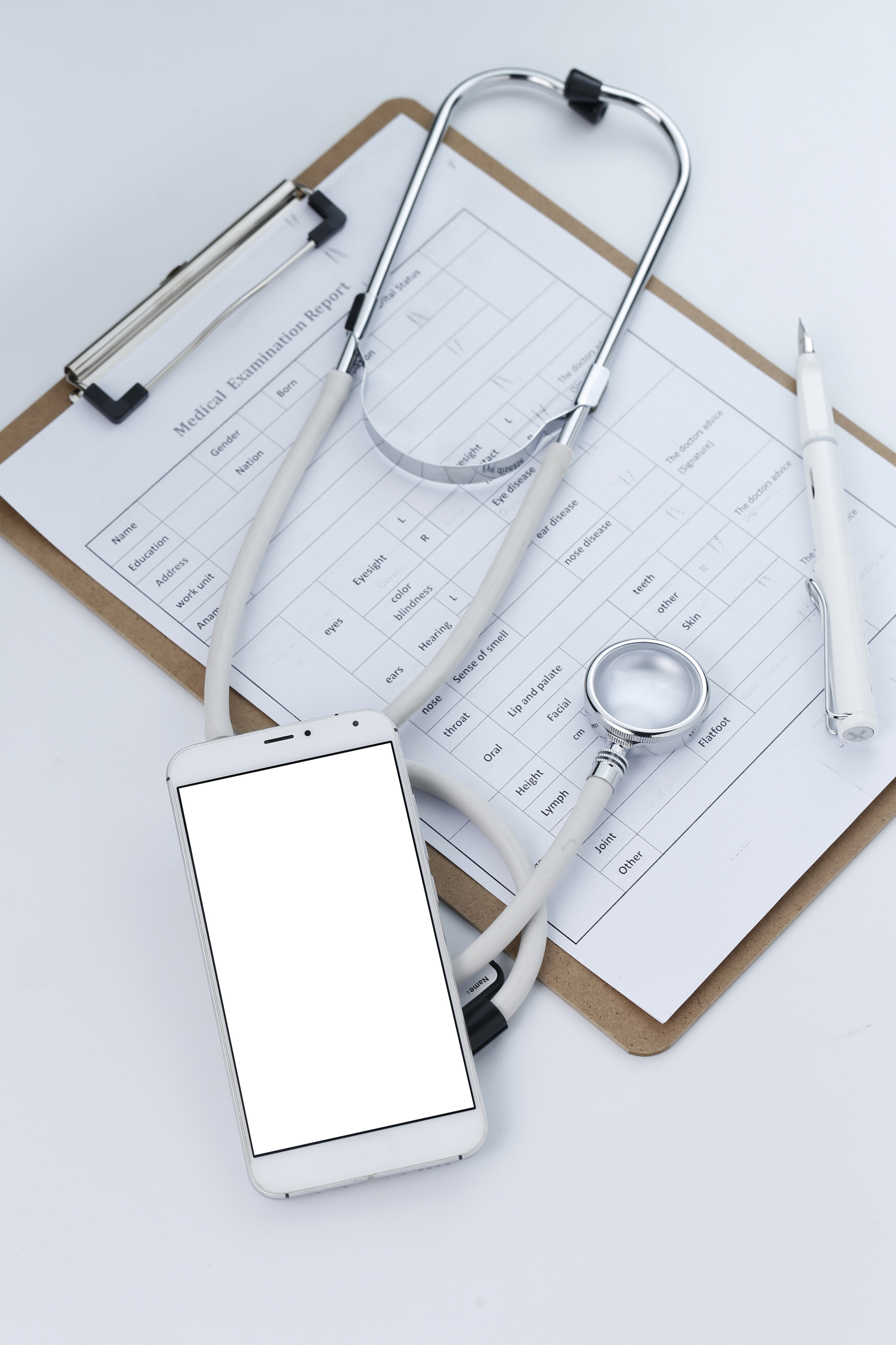 Mobile phone, stethoscope and chart file on the desktop (mobile medical, handheld doctor concepts)