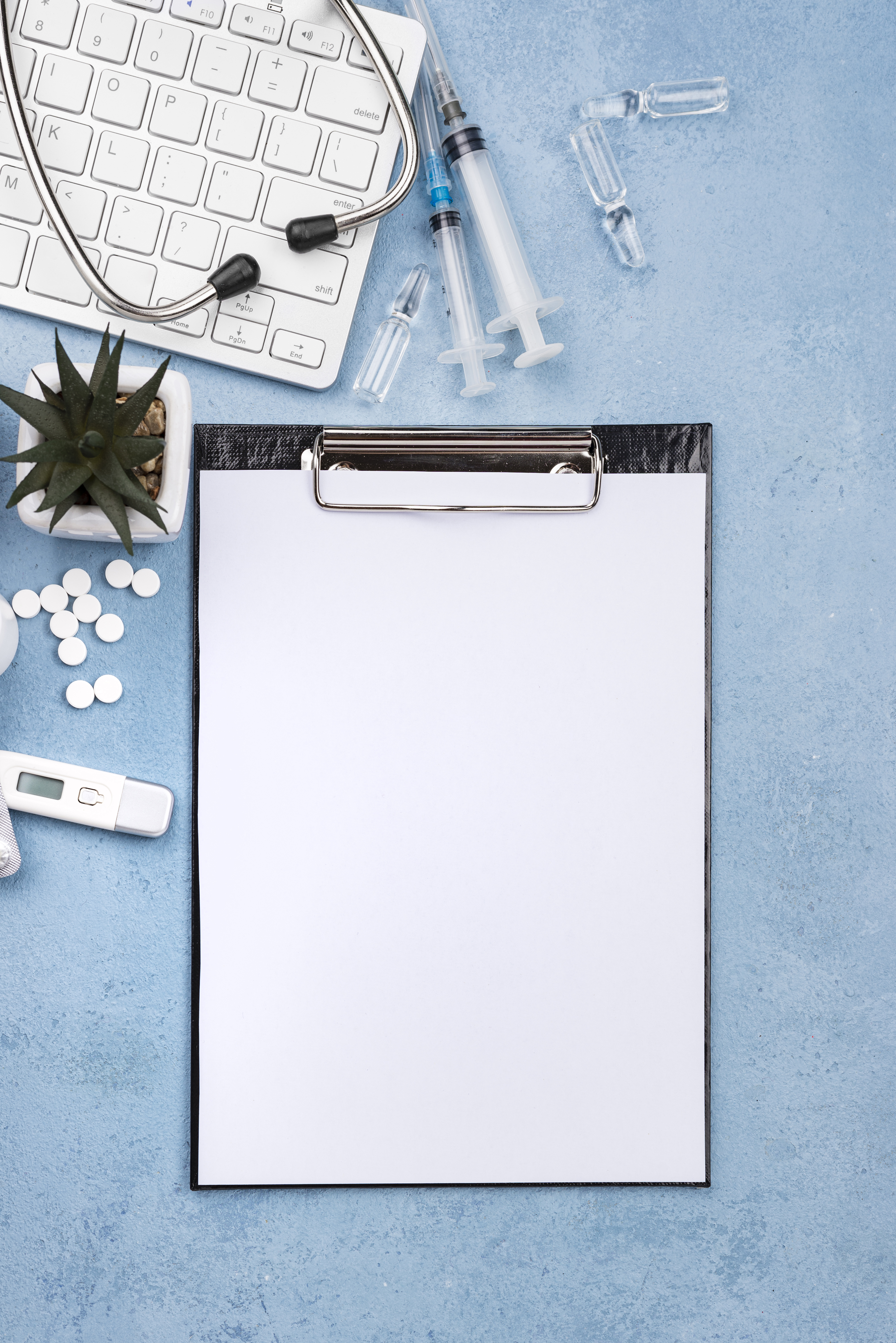 top-view-medical-desk-arrangement-with-empty-clipboard